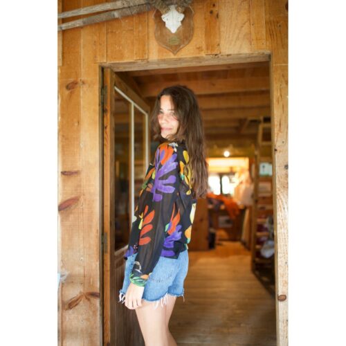 Femme portant la chemise G.KERO NERO FRUTAD en coton et soie, imprimé abstrait coloré, idéale pour un style audacieux. Vue de dos